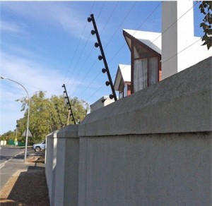 electric fence on top of a wall